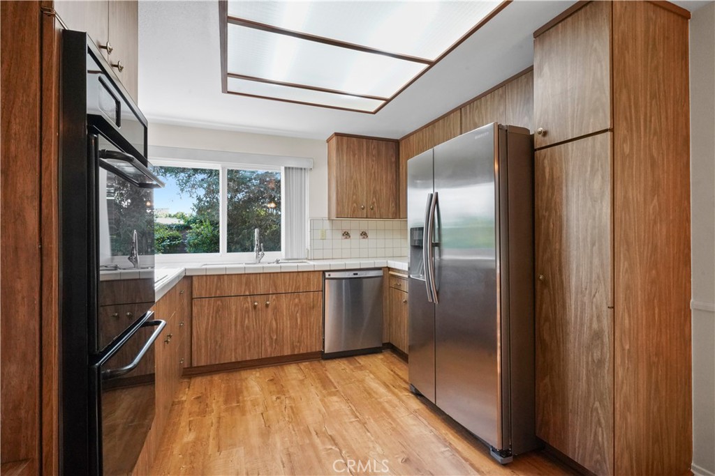 3136 Voltaire Drive Topanga, CA 90290 - Photo 13 of 48 a kitchen with stainless steel appliances granite countertop a refrigerator and a sink