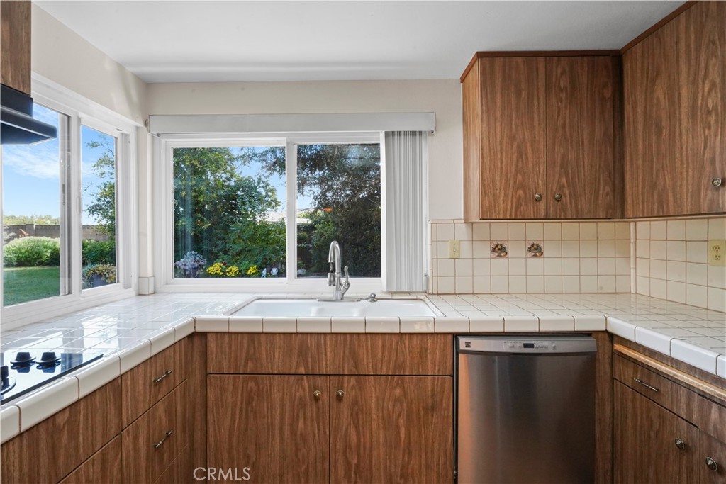 3136 Voltaire Drive Topanga, CA 90290 - Photo 14 of 48 a kitchen with granite countertop wooden cabinets a sink and a window