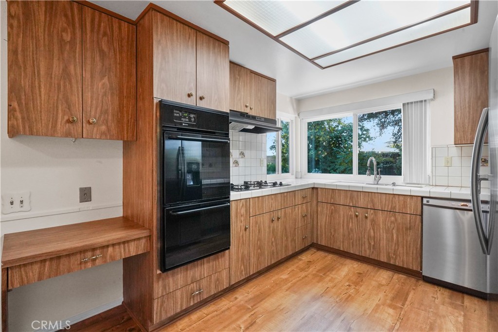 3136 Voltaire Drive Topanga, CA 90290 - Photo 16 of 48 a kitchen with stainless steel appliances granite countertop a refrigerator and a sink