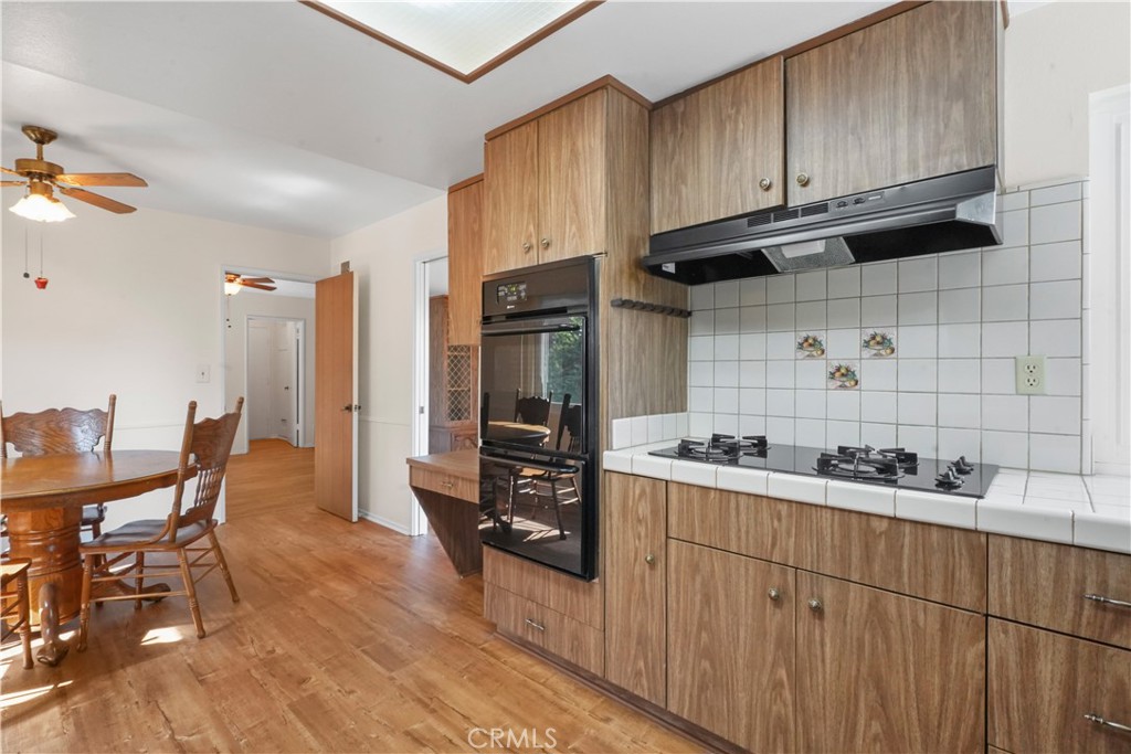 3136 Voltaire Drive Topanga, CA 90290 - Photo 17 of 48 a kitchen with stainless steel appliances wooden cabinets and a stove top oven