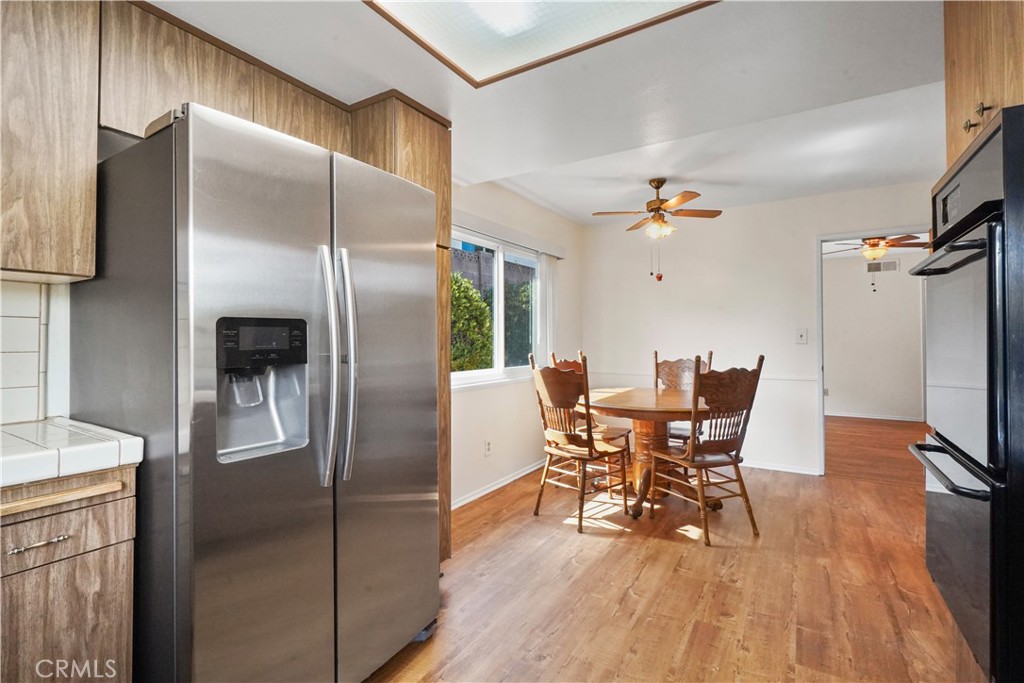 3136 Voltaire Drive Topanga, CA 90290 - Photo 18 of 48 a dining room with stainless steel appliances a table chairs and a refrigerator