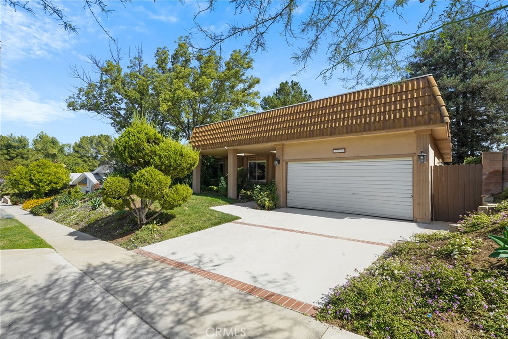 3136 Voltaire Drive Topanga, CA 90290 - Photo 42 of 48 a front view of a house with a yard and garage