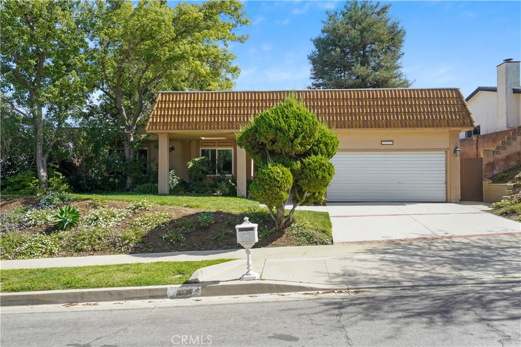 3136 Voltaire Drive Topanga, CA 90290 - Photo 43 of 48 a front view of a house with a yard and a garage