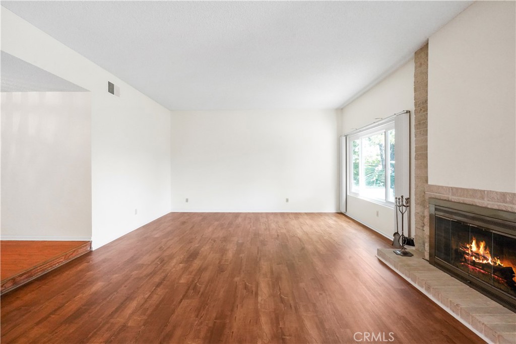 3136 Voltaire Drive Topanga, CA 90290 - Photo 7 of 48 a view of empty room with wooden floor and fireplace
