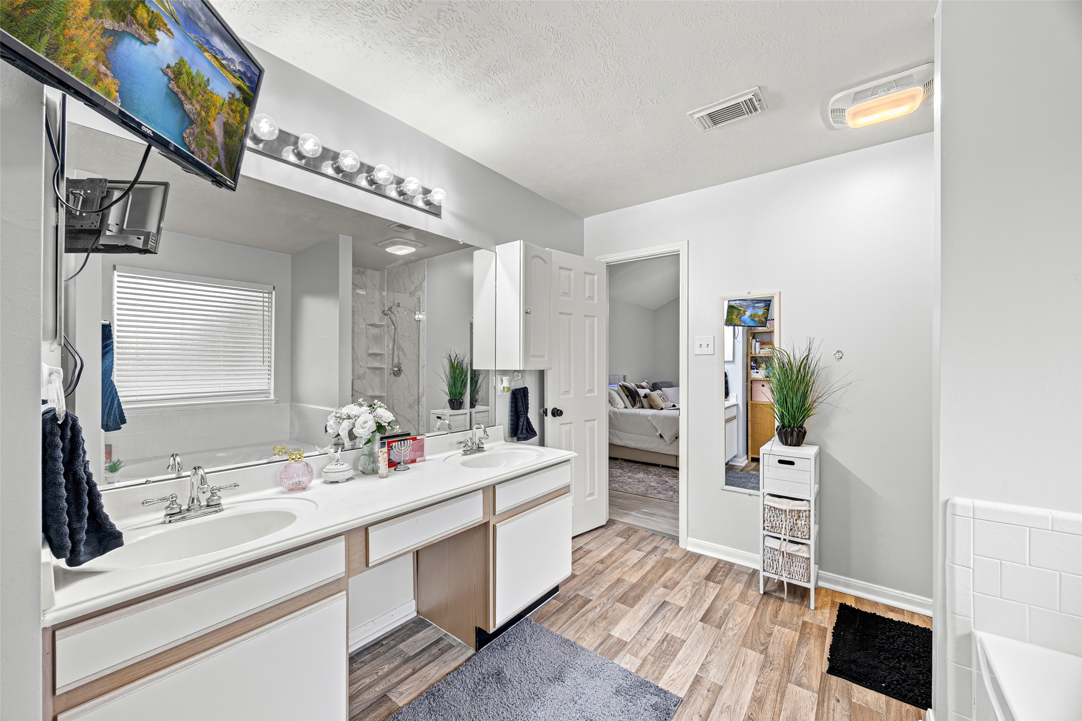 2710 Fox View Circle Spring, TX 77386 - Photo 20 of 29 a spacious bathroom with a double vanity sink a mirror and a shower