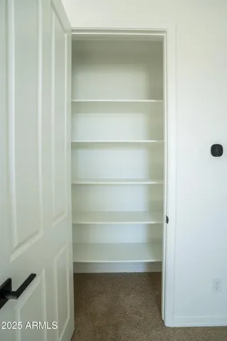 a white toilet sitting next to a white sink