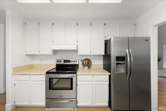 a kitchen with cabinets and stainless steel appliances