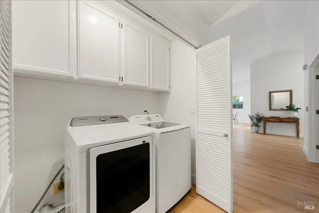 a view of a room with wooden floor cabinet and a bathroom
