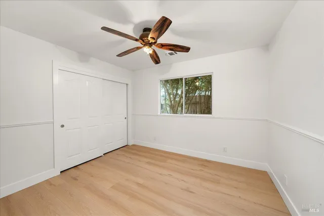 a bathroom with a granite countertop sink a toilet and a large mirror