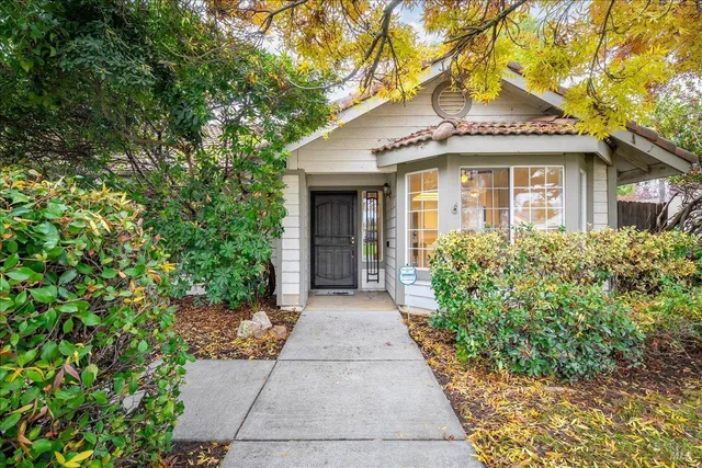 a living room with furniture a fireplace and a window
