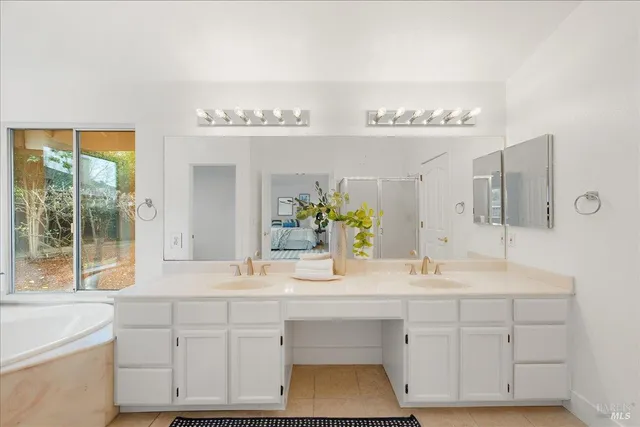 a backyard of a house with large trees and wooden fence