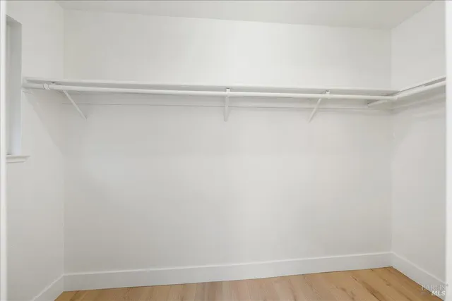 a backyard of a house with large trees and outdoor seating