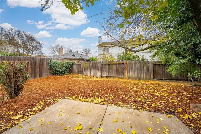 a front view of a house with a garden and yard
