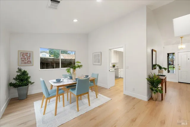 a bathroom with a double vanity sink a large mirror and a bathtub