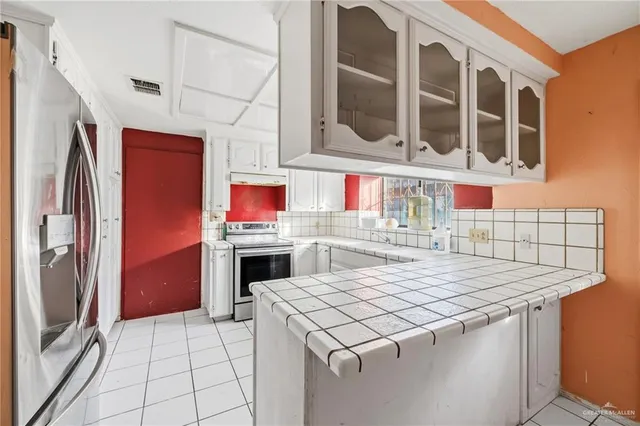 a kitchen with stainless steel appliances granite countertop a stove and a refrigerator