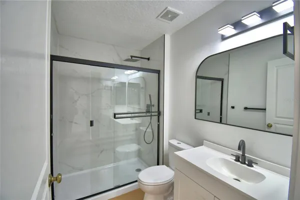 a bathroom with a glass shower door