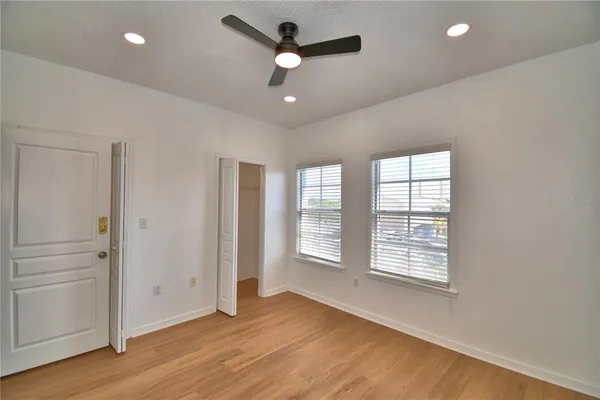 a view of an empty room with wooden floor