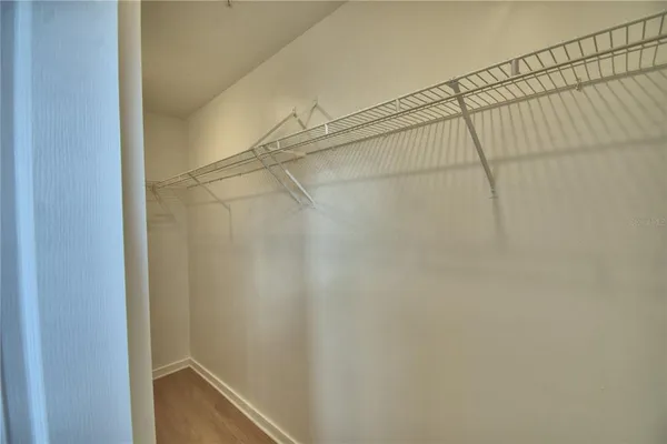 a view of walk in closet with empty racks