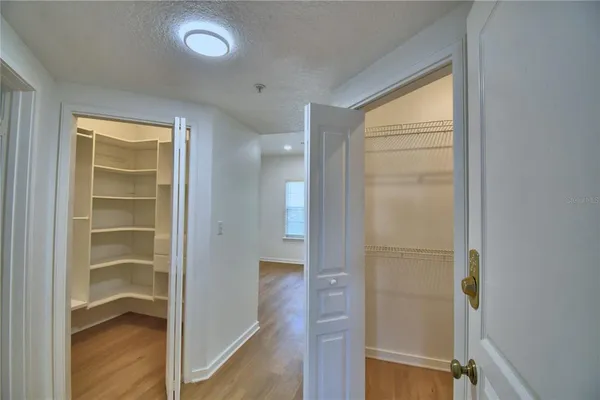 a view of an empty walk in closet with empty racks