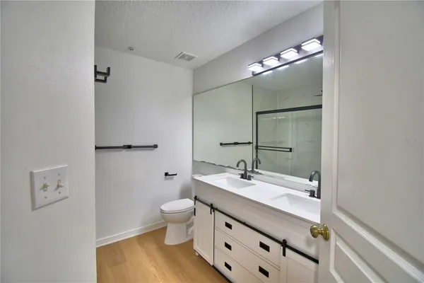 a bathroom with a glass shower door and a shower