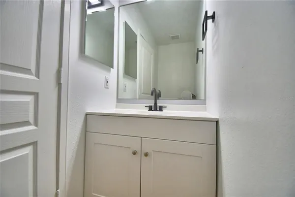 a view of a kitchen with granite countertop white cabinets and white appliances