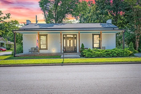 a large kitchen with kitchen island a large island in the center a sink stainless steel appliances and cabinets