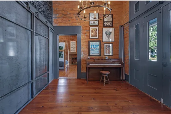 a kitchen with cabinets and wooden floor