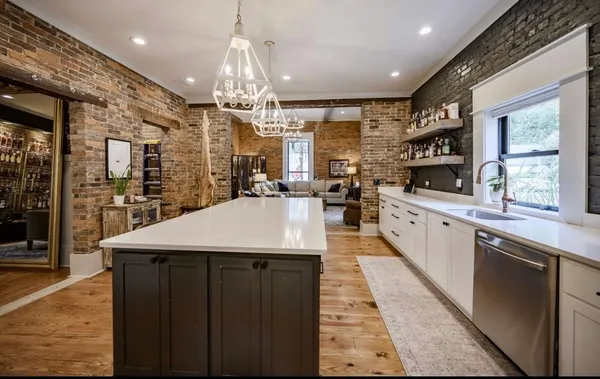 a kitchen with stainless steel appliances granite countertop a sink and a refrigerator
