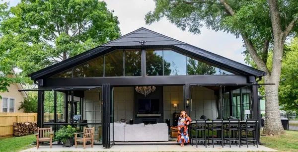 a kitchen with stainless steel appliances granite countertop a stove top oven a sink dishwasher a dining table and chairs with wooden floor