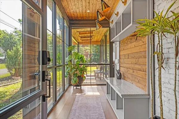 an aerial view of residential houses with outdoor space and trees