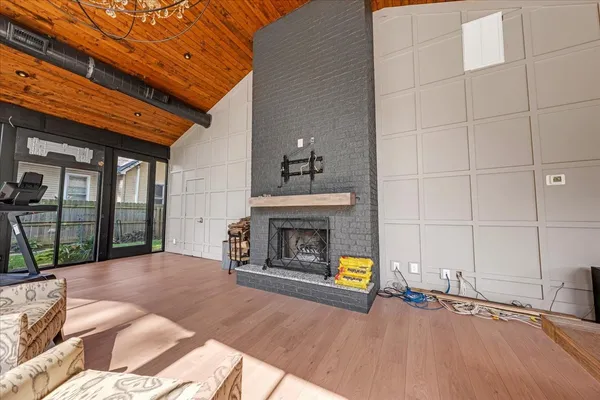 a living room with patio furniture and a garden