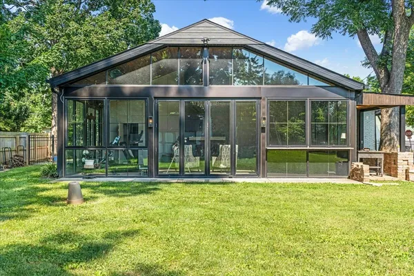a view of house with outdoor space and tub