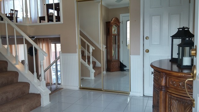 21W162 Coronet Road Lombard, IL 60148 - Photo 3 of 15 a view of staircase with lots of frames on wall and a wooden floor