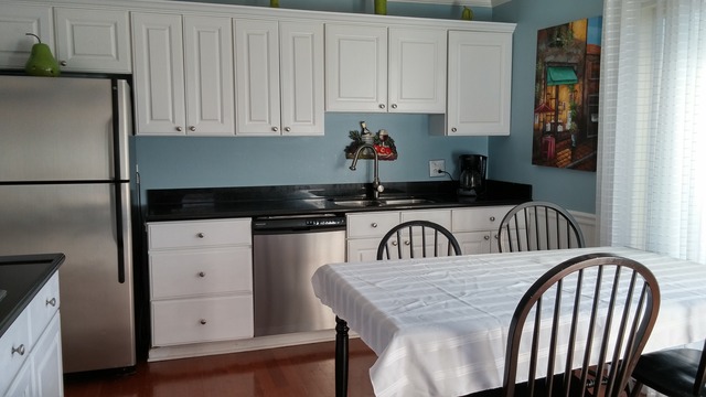 21W162 Coronet Road Lombard, IL 60148 - Photo 5 of 15 a kitchen with granite countertop a refrigerator a stove a sink and white cabinets with wooden floor