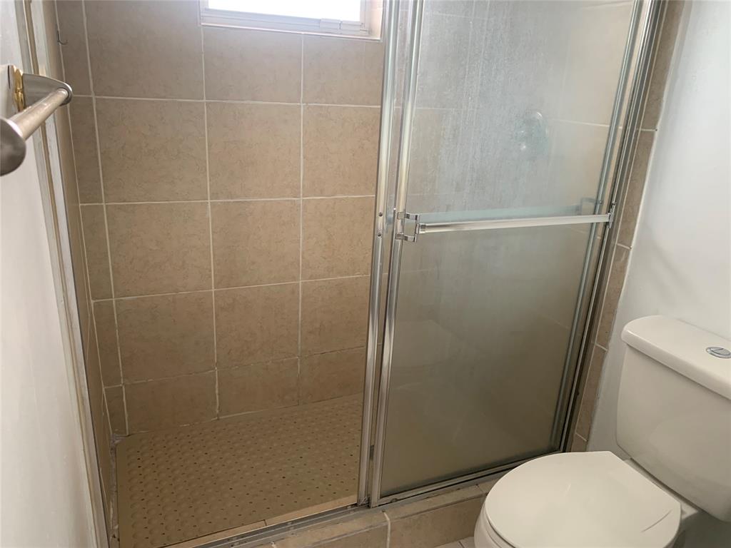 4243 Northwest 68 Way, Unit 4243 Fort Lauderdale, FL 33319 - Photo 3 of 15 a white toilet sitting next to a shower