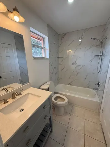 a bathroom with a sink a toilet and bathtub