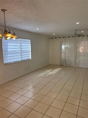 a view of an empty room and a window