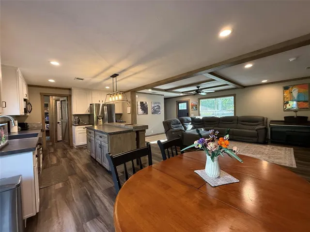 a kitchen with stainless steel appliances granite countertop a stove and a refrigerator