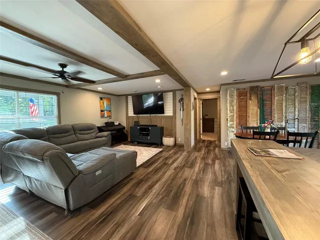a living room with lots of furniture and kitchen view