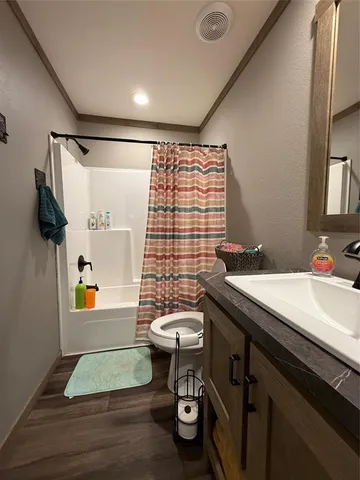 a bedroom with a bed next to a window