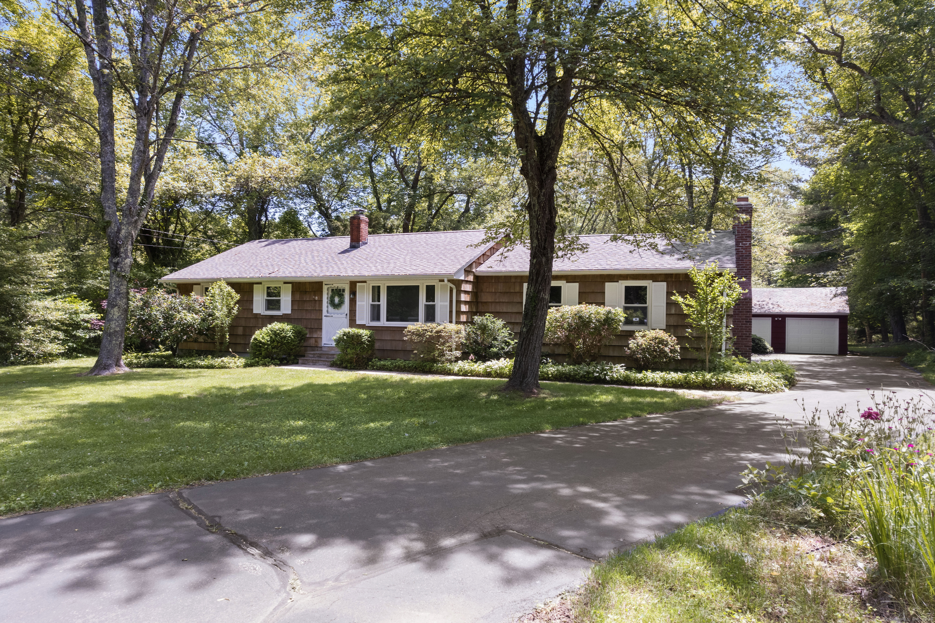 17 Boston Post Road Old Lyme, CT 06371 - Photo 1 of 1 a front view of a house with yard and trees