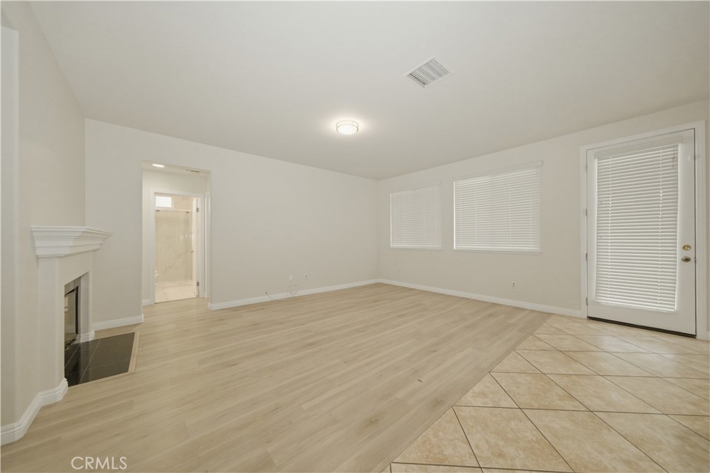 6710 Black Hawk Road Eastvale, CA 92880 - Photo 14 of 49 wooden floor in an empty room with a fireplace