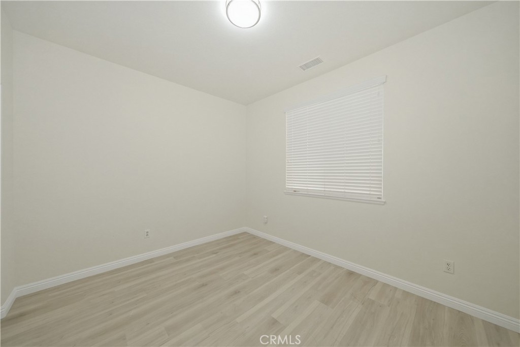 6710 Black Hawk Road Eastvale, CA 92880 - Photo 18 of 49 a view of a room with wooden floor and white walls