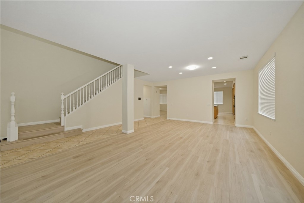 6710 Black Hawk Road Eastvale, CA 92880 - Photo 5 of 49 a view of an empty room with wooden floor and entryway