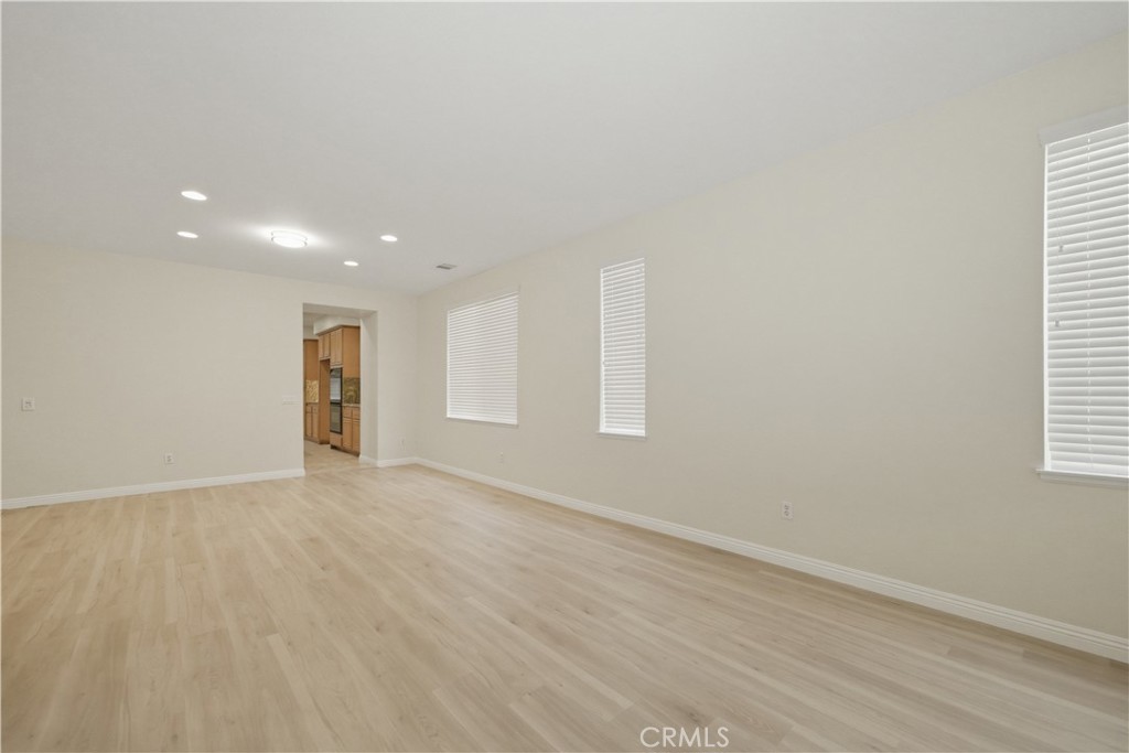 6710 Black Hawk Road Eastvale, CA 92880 - Photo 6 of 49 an empty room with wooden floor and windows