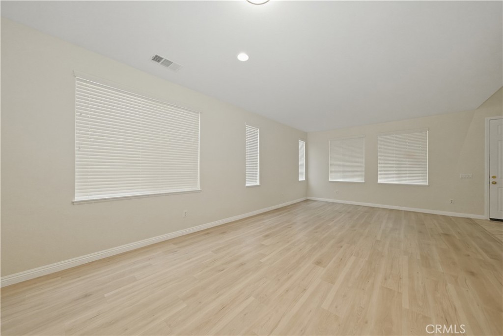 6710 Black Hawk Road Eastvale, CA 92880 - Photo 7 of 49 wooden floor in an empty room with a window
