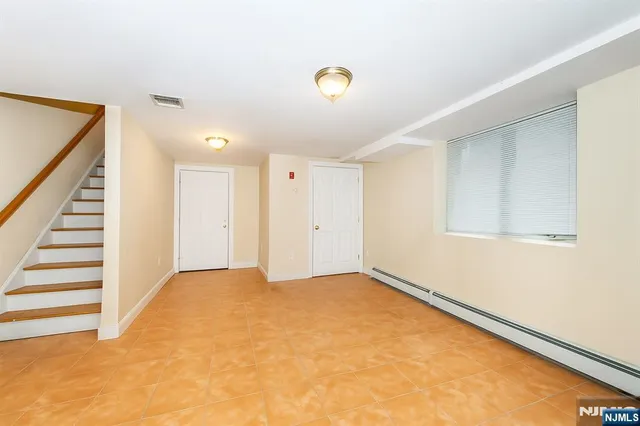 a view of an empty room with stairs
