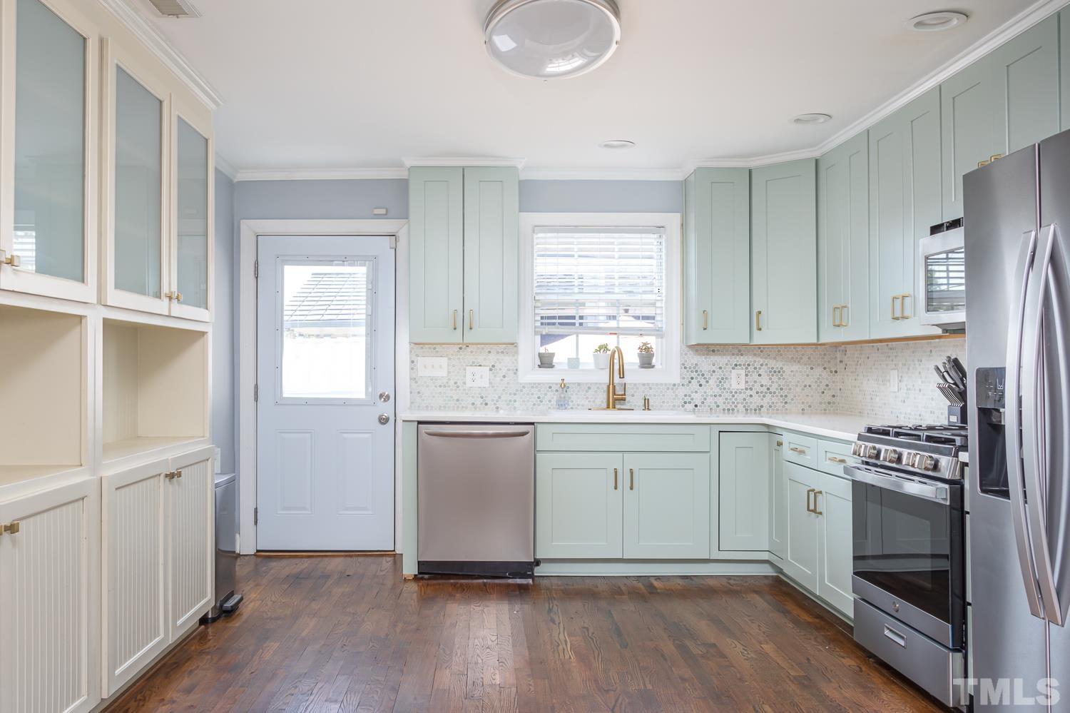 610 East Martin Street Raleigh, NC 27601 - Photo 11 of 40 a kitchen with a sink cabinets stainless steel appliances and window