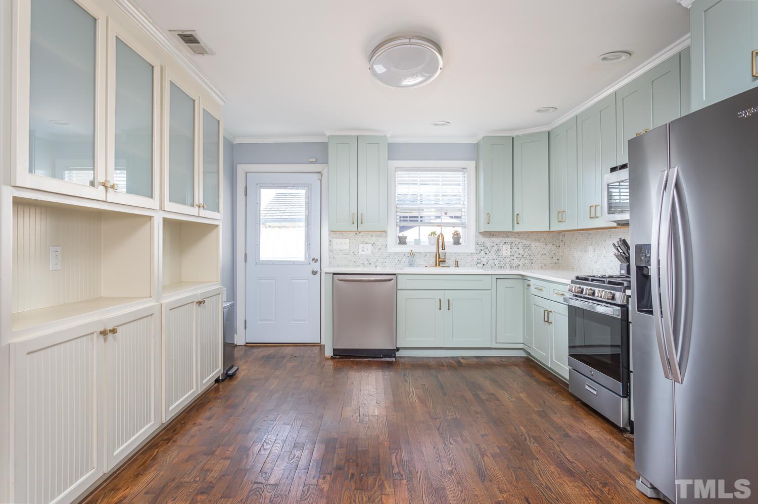 610 East Martin Street Raleigh, NC 27601 - Photo 12 of 40 a kitchen with a sink cabinets stainless steel appliances and window