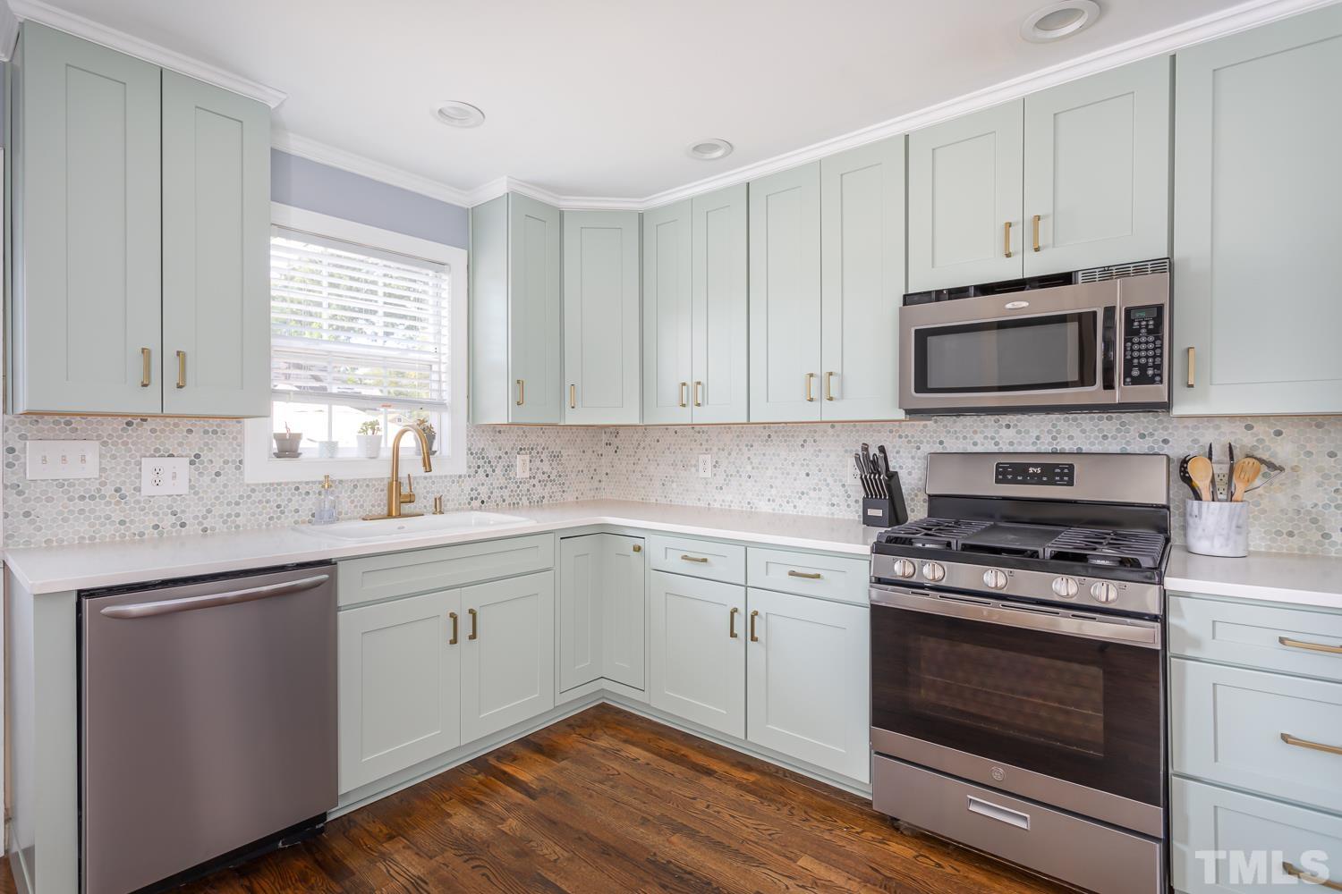 610 East Martin Street Raleigh, NC 27601 - Photo 13 of 40 a kitchen with cabinets stainless steel appliances a sink and a window